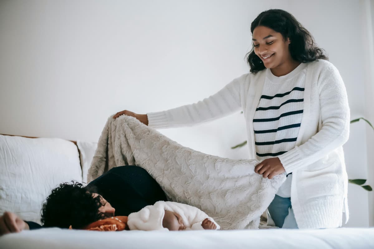 New mother resting in the fourth trimester after birth in a calm, nurturing home setting